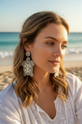 Model wearing smaller silver turtle earrings