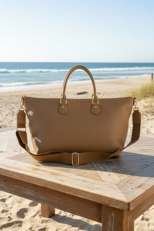 Smooth tan tote bag on beach table